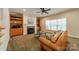 Inviting living room with built-in shelves, cozy fireplace, and ample natural light from the large window at 4599 Rustling Woods Dr, Denver, NC 28037