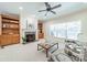 Bright living room featuring built-in bookshelves, a fireplace, and large windows at 4599 Rustling Woods Dr, Denver, NC 28037