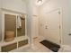 Mudroom with a coat rack, bench, storage basket, neutral paint, and tiled floors at 4599 Rustling Woods Dr, Denver, NC 28037