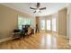 A bright office space with natural light, hardwood flooring, and a ceiling fan at 4599 Rustling Woods Dr, Denver, NC 28037