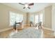 Bright sitting room with hardwood floors, large windows and comfortable seating at 4599 Rustling Woods Dr, Denver, NC 28037
