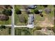 Aerial view showcasing a landscaped property with a brick home, long driveway, and lush greenery at 5119 Blackberry Ln, Matthews, NC 28104