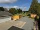 Aerial view of backyard featuring a garage, gravel parking area, and wooden fence at 5119 Blackberry Ln, Matthews, NC 28104