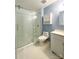 Full bathroom with a sliding glass door shower, white fixtures, and blue accent wall at 5119 Blackberry Ln, Matthews, NC 28104