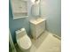Compact bathroom with a white vanity, toilet, cabinet, and patterned tile floor at 5119 Blackberry Ln, Matthews, NC 28104