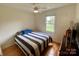 Cozy bedroom with hardwood floors, a ceiling fan, and a view of the outdoors at 5119 Blackberry Ln, Matthews, NC 28104