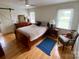 Cozy bedroom with hardwood floors, a ceiling fan, and a comfortable bed with side tables, offering a tranquil retreat at 5119 Blackberry Ln, Matthews, NC 28104