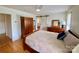 Well-lit bedroom featuring hardwood floors, a barn door, and a comfortable bed with ample storage, creating a serene space at 5119 Blackberry Ln, Matthews, NC 28104