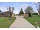 Long driveway leading to a brick home and garage, enhanced by newly built wooden fences at 5119 Blackberry Ln, Matthews, NC 28104