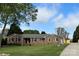 Charming single-story brick home with a well-manicured lawn and mature trees at 5119 Blackberry Ln, Matthews, NC 28104