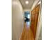 Hallway leading to a bedroom, featuring hardwood floors and closet space at 5119 Blackberry Ln, Matthews, NC 28104