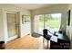 Bright home office featuring a desk area, sliding glass doors to the yard, and a view of the outdoor greenery at 5119 Blackberry Ln, Matthews, NC 28104