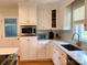 Bright kitchen with white cabinetry, stainless appliances, and corner sink at 5119 Blackberry Ln, Matthews, NC 28104