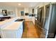 Kitchen with stainless steel appliances, white cabinets, and hardwood flooring at 5119 Blackberry Ln, Matthews, NC 28104