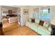 Charming sunroom with hardwood floors, a comfortable sofa, and windows offering natural light and scenic views at 5119 Blackberry Ln, Matthews, NC 28104