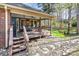 Inviting backyard patio with outdoor seating and views of the private, wooded lot at 5125 Waxwind Ln, Charlotte, NC 28226