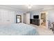 Cozy bedroom with light blue bedding, lots of closet space, and access to the en suite bathroom at 5125 Waxwind Ln, Charlotte, NC 28226