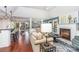 Bright living room features a fireplace, wood floors, and an open floor plan at 5125 Waxwind Ln, Charlotte, NC 28226