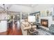 Bright living room features a fireplace, wood floors, and an open floor plan at 5125 Waxwind Ln, Charlotte, NC 28226
