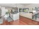 Open-concept living room showcases an island and flows into the kitchen with wood flooring at 5125 Waxwind Ln, Charlotte, NC 28226