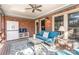 Covered outdoor patio featuring comfortable seating, ceiling fan, and brick accents at 5125 Waxwind Ln, Charlotte, NC 28226