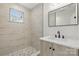 New bathroom boasts stylish tile, a marble countertop vanity, modern fixtures, and a walk-in shower at 530 S Trenton St, Gastonia, NC 28052