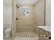 Modern bathroom showcasing a pebble floor shower, tiled walls, and sleek fixtures at 530 S Trenton St, Gastonia, NC 28052