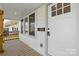 Inviting front porch with wood flooring, freshly painted white siding, and natural wood trim at 530 S Trenton St, Gastonia, NC 28052