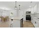 Bright kitchen features stainless appliances, white cabinets, granite countertops, and an island with pendant lighting at 530 S Trenton St, Gastonia, NC 28052