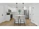 Modern kitchen features white cabinets, stainless steel appliances, granite countertops, and a central island at 530 S Trenton St, Gastonia, NC 28052