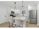 Modern kitchen features white cabinets, stainless steel appliances, granite countertops, and a central island at 530 S Trenton St, Gastonia, NC 28052