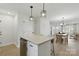Bright kitchen island with pendant lighting, stainless appliances, and a view into the dining and living area at 530 S Trenton St, Gastonia, NC 28052