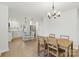 Open layout with a dining area and a modern kitchen featuring white cabinets and an island at 530 S Trenton St, Gastonia, NC 28052