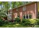 Backyard of a brick home with mature trees and landscaped patio and lawn at 5510 Sardis Rd, Charlotte, NC 28270