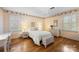 Bedroom with hardwood floors, bright windows, floral wallpaper, and white furniture at 5510 Sardis Rd, Charlotte, NC 28270