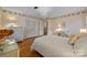 Bedroom with hardwood floors, floral wallpaper, white furniture, and chandelier at 5510 Sardis Rd, Charlotte, NC 28270