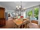Bright dining area with terracotta floors, natural light and a view into the kitchen at 5510 Sardis Rd, Charlotte, NC 28270