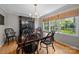 Formal dining room with hardwood floors, a dark wood table, and natural lighting at 5510 Sardis Rd, Charlotte, NC 28270