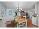 Inviting dining area with light blue walls, a rustic wooden table, and a view into the cozy living room at 5510 Sardis Rd, Charlotte, NC 28270