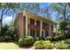 Attractive two-story brick home with a covered porch, mature landscaping, and classic architectural details at 5510 Sardis Rd, Charlotte, NC 28270