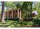 Charming two-story brick home with white columns, lush landscaping, and mature trees on a sunny day at 5510 Sardis Rd, Charlotte, NC 28270