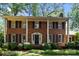 Beautiful brick two-story home featuring symmetrical design and inviting entrance with a covered porch at 5510 Sardis Rd, Charlotte, NC 28270