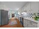Cozy kitchen with blue and white tiles, modern appliances, and access to a dining area at 5510 Sardis Rd, Charlotte, NC 28270