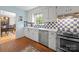 Bright kitchen with white cabinets, stainless steel appliances, and a view into the dining room at 5510 Sardis Rd, Charlotte, NC 28270