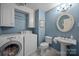 Blue laundry room featuring a washing machine, a dryer and a sink at 5510 Sardis Rd, Charlotte, NC 28270