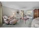 Cozy living room featuring neutral walls, plush seating, and seamless flow into the adjacent dining area at 5510 Sardis Rd, Charlotte, NC 28270