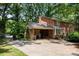Rear exterior view of a brick house with a driveway and an attached garage at 5510 Sardis Rd, Charlotte, NC 28270