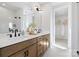 Well-lit bathroom with double vanity, wooden cabinets, and a glass-enclosed shower at 5604 Kingspan Dr, Charlotte, NC 28217