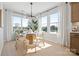 Bright dining area boasts a modern chandelier, large windows, and an adjacent cabinet at 5604 Kingspan Dr, Charlotte, NC 28217
