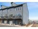 Three-story townhome with a balcony and a private entrance, offering a contemporary design at 5604 Kingspan Dr, Charlotte, NC 28217